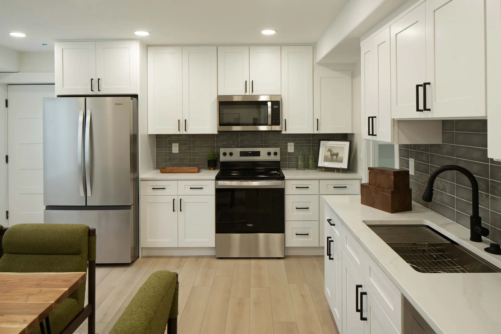 Lower kitchenette, green chairs