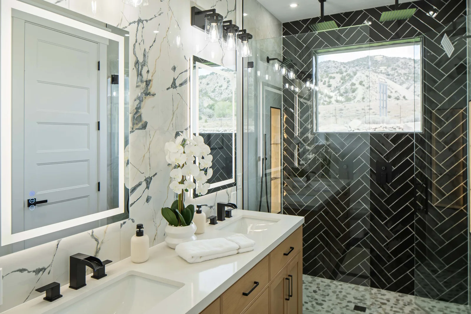 Book-matched marble and a black herringbone shower