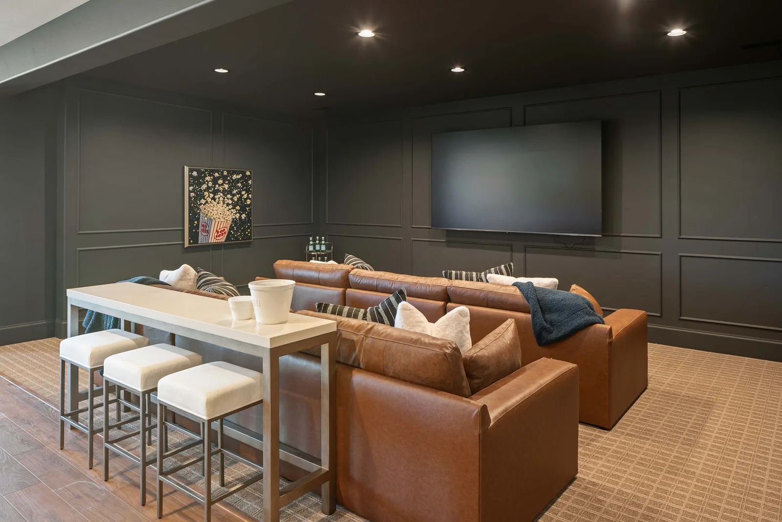 Charcoal panels and a leather sectional