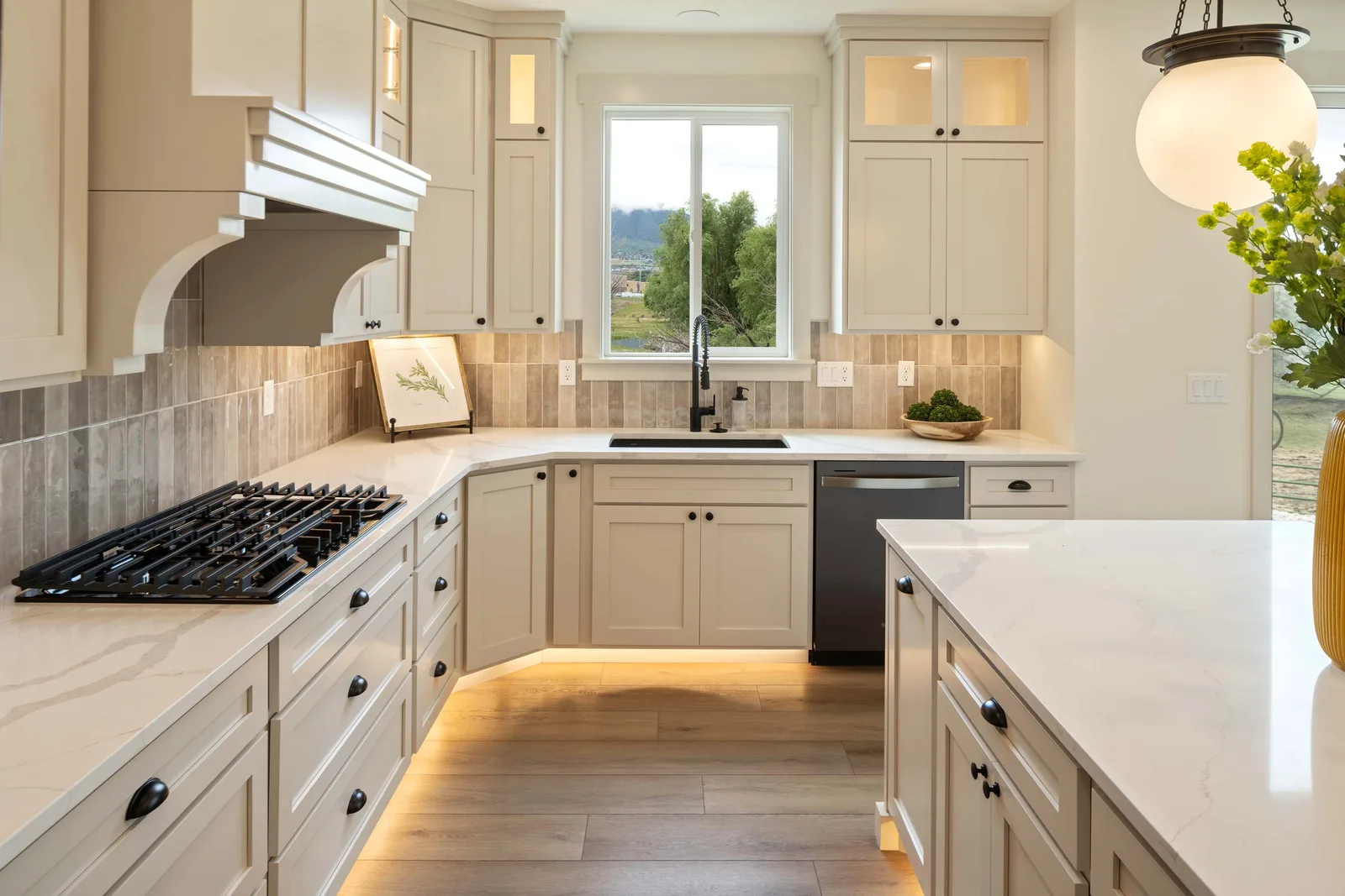 Cream cabinets, black steel appliances