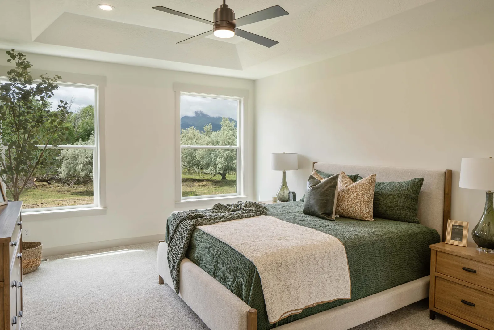 Olive bedding under a tray ceiling